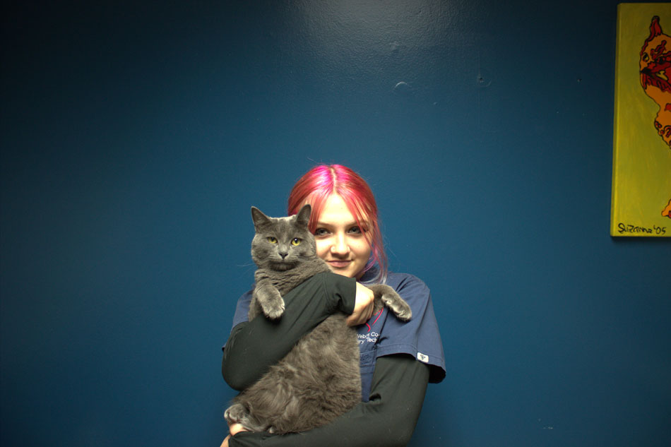 Savannah Weber posing with a large dark grey cat.